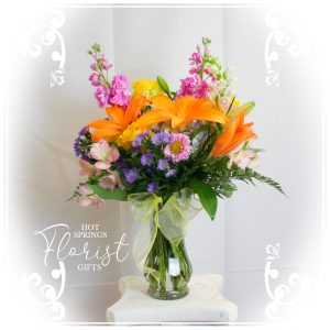 Beautiful boquet of flowers with orange, green, and purple notes