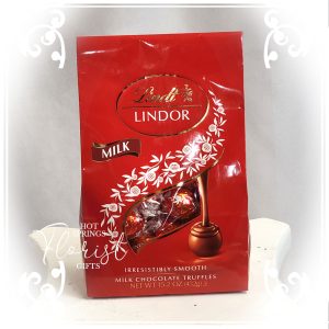 A bag of Add Lindt Lindor Truffles - Large (15.2oz) Chocolates on a white surface.
