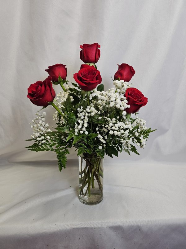 The "Valentine Special: Half Dozen Roses" features a glass vase with six red roses, white baby's breath, and green foliage on a plain white background.